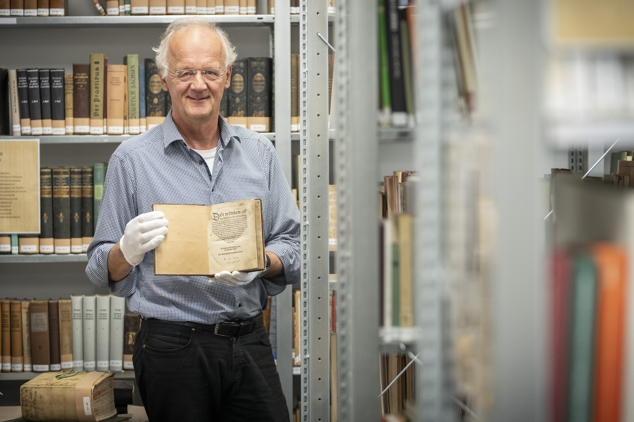Gisbert Strotdrees with the book „Der Feldbau“, the oldest book in the Westphalian Library of Agriculture from 1545